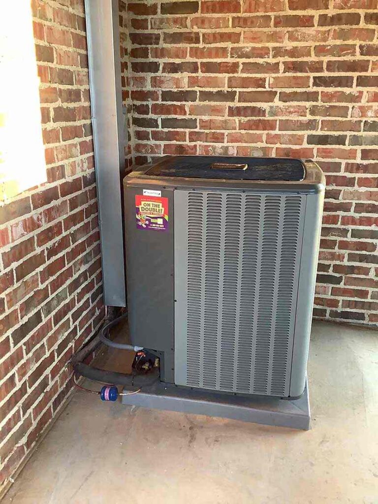 Technician tinkering with an AC unit Lubbock, TX