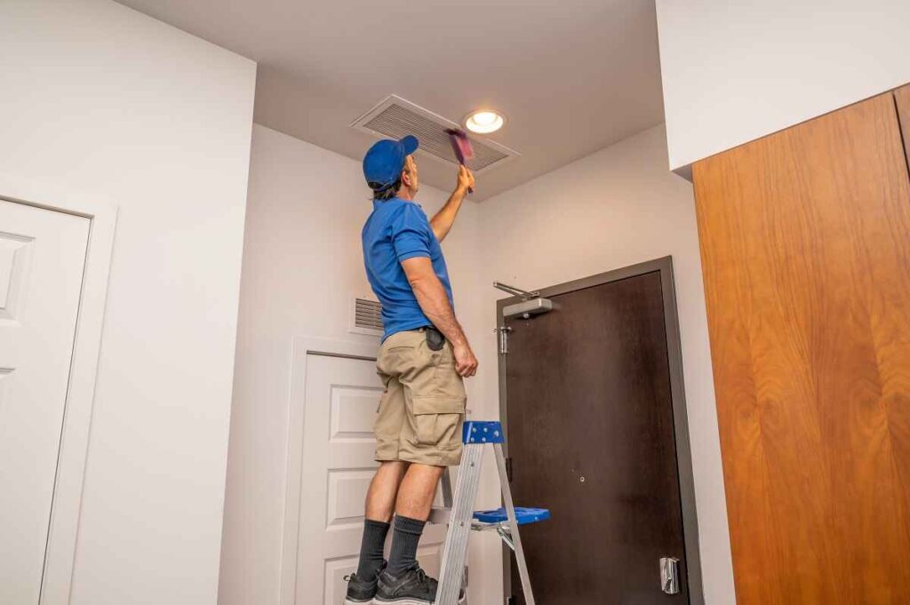 On the Double technician cleaning air ducts