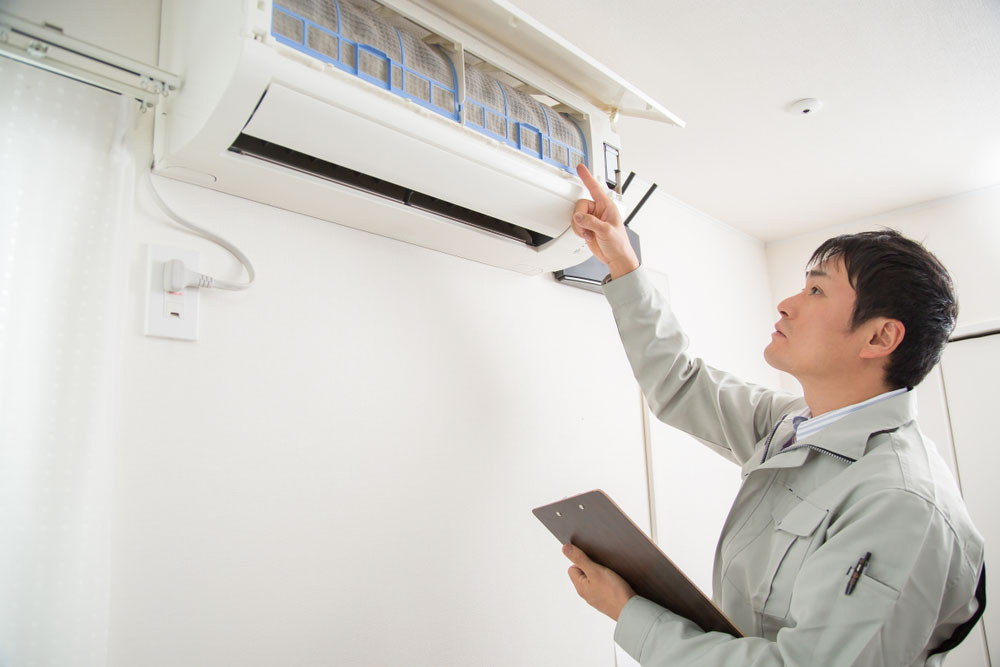 HVAC tech looking at AC