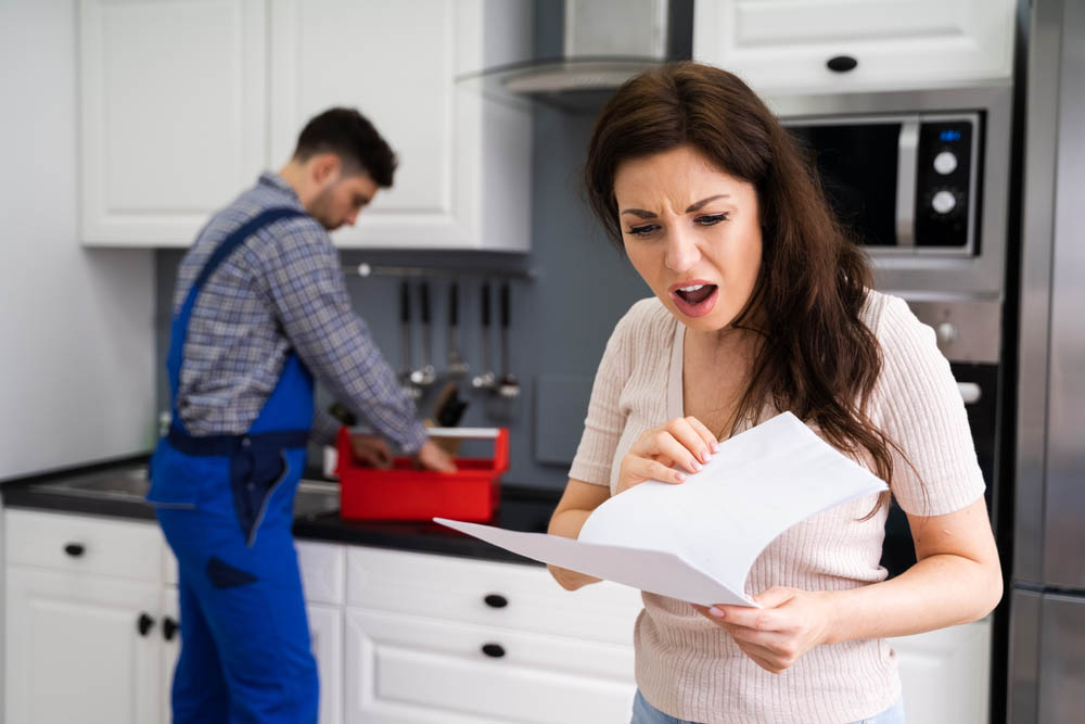 homeowner holding a bunch of repair bills