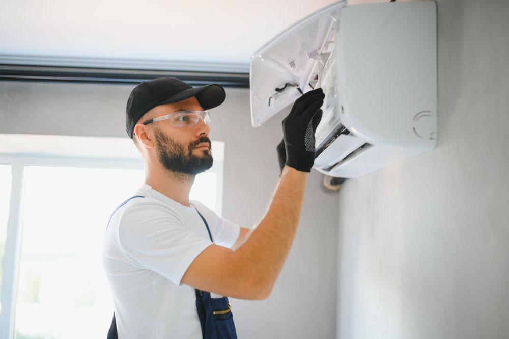 HVAC tech looking at AC unit