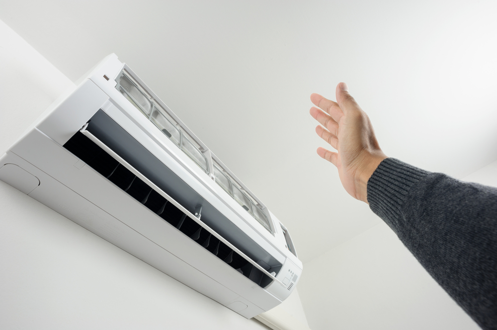 person checking AC air flow